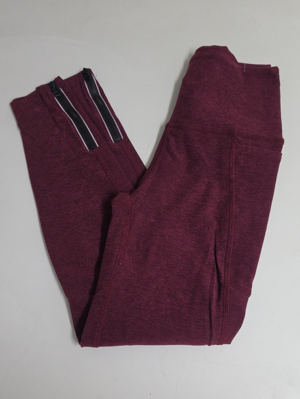 Cropped leggings feature a high-rise waistband, drop-in side pockets, and ankle